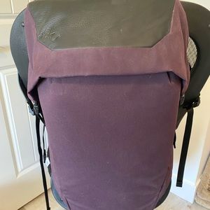 Selling an RYU backpack in an eggplant colour with black leather detailing.